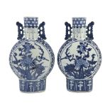 A pair of Chinese blue and white moon flasks, 19th century, each painted with birds amid flowers and