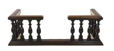 A 19th century brass mounted oak club fender, with baluster frieze and plinth foot, width 182cm