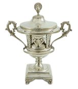 A 19th century ornate French pierced silver two handled urn shaped vase and cover, with peacock