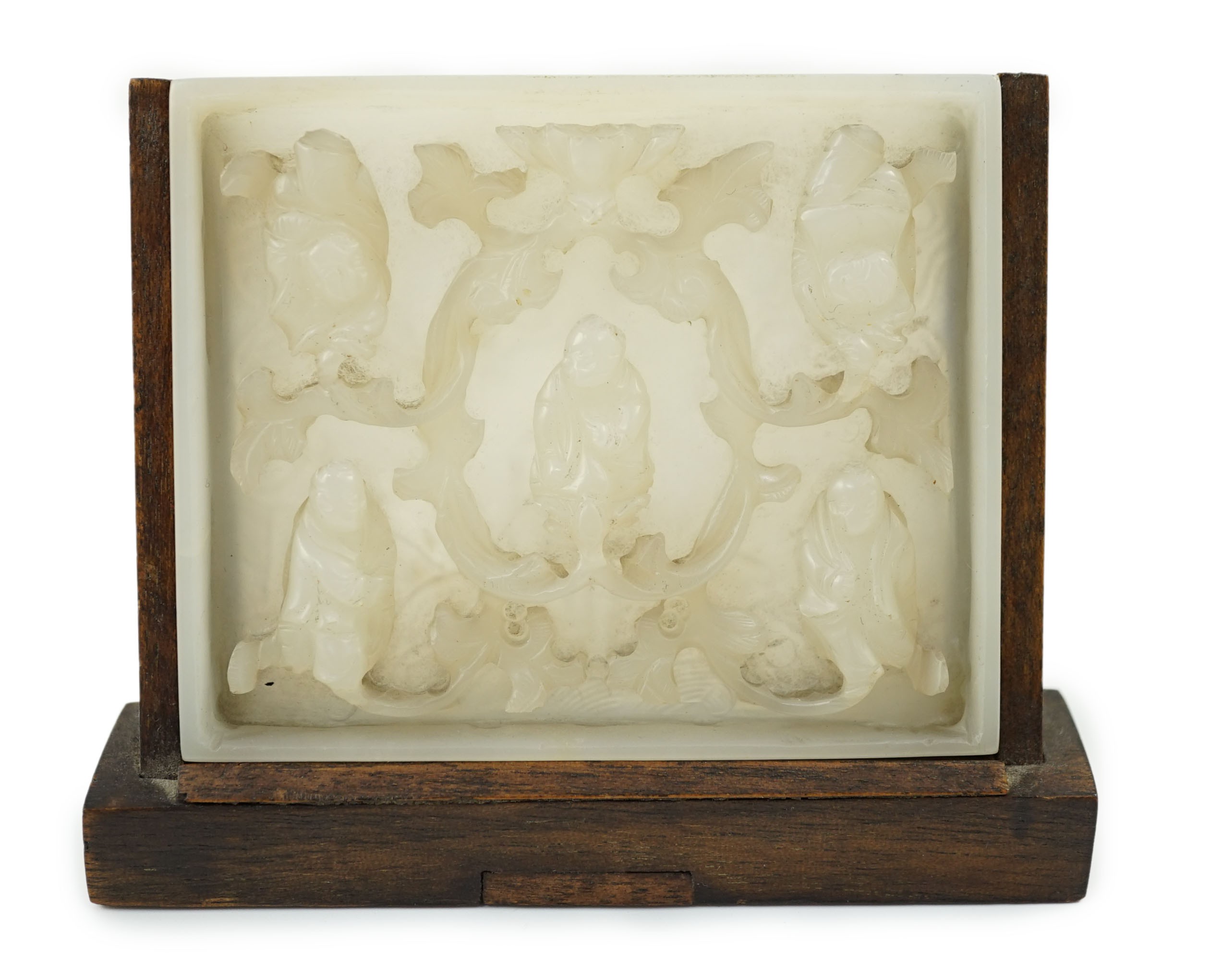 An unusual Chinese white jade plaque, 18th/19th century, carved in high relief with three seated