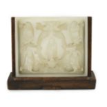 An unusual Chinese white jade plaque, 18th/19th century, carved in high relief with three seated