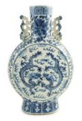 A Chinese blue and white ‘dragon’ moonflask, 19th century, each side painted with two confronting