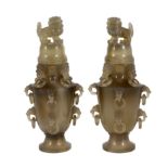 A pair of Chinese agate vases and covers, early 20th century, each baluster shaped body carved