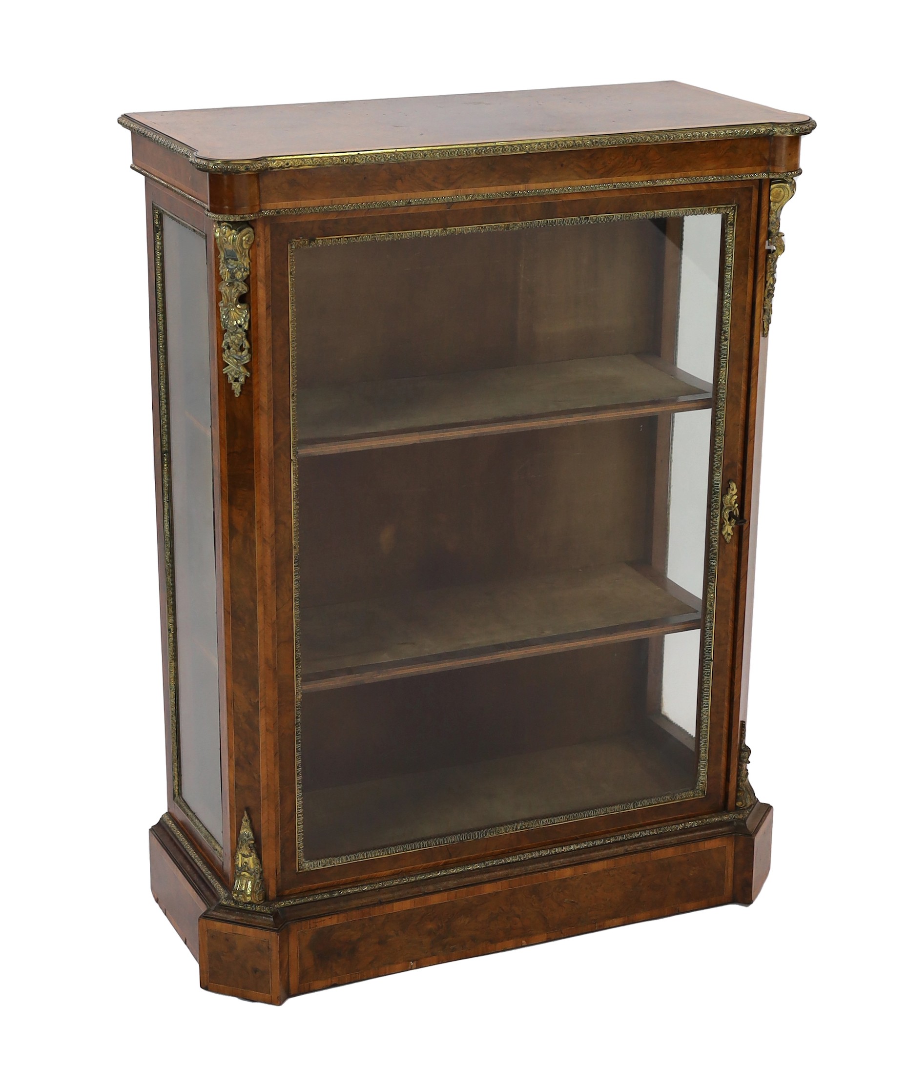 A 19th century French ormolu mounted figured walnut pier cabinet, with single glazed door and plinth