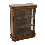 A 19th century French ormolu mounted figured walnut pier cabinet, with single glazed door and plinth