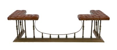 A Victorian style brass club fender, with buttoned brown leather seats and foliate motifs to the