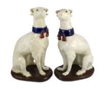 A pair of Italian tin-glaze earthenware figures of seated greyhounds, 35cm high***CONDITION