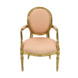 A George III Adam style giltwood armchair, with moulded frame, upholstered arms back and seat and