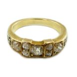 A late 19th century gold and seven stone old mine cut diamond and black enamelled cluster half