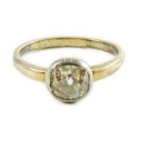 An antique yellow metal and collet set solitaire old cushion cut diamond ring, size N, gross