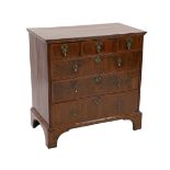 A George I crossbanded walnut chest, of three short and three graduated long drawers, oak sides,