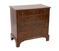 A George I crossbanded walnut chest, of three short and three graduated long drawers, oak sides,