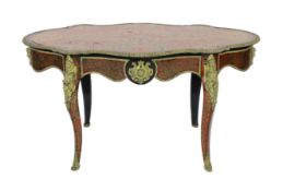 A 19th century French red boulle bureau plat, of serpentine oval form with foliate scrolling