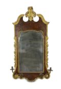 A George II and later carved giltwood and burr walnut wall mirror, the cartouche shaped crest