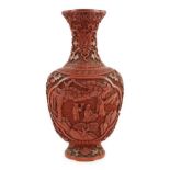 A Chinese cinnabar lacquer flattened baluster vase, 18th/19th century, carved in high relief with