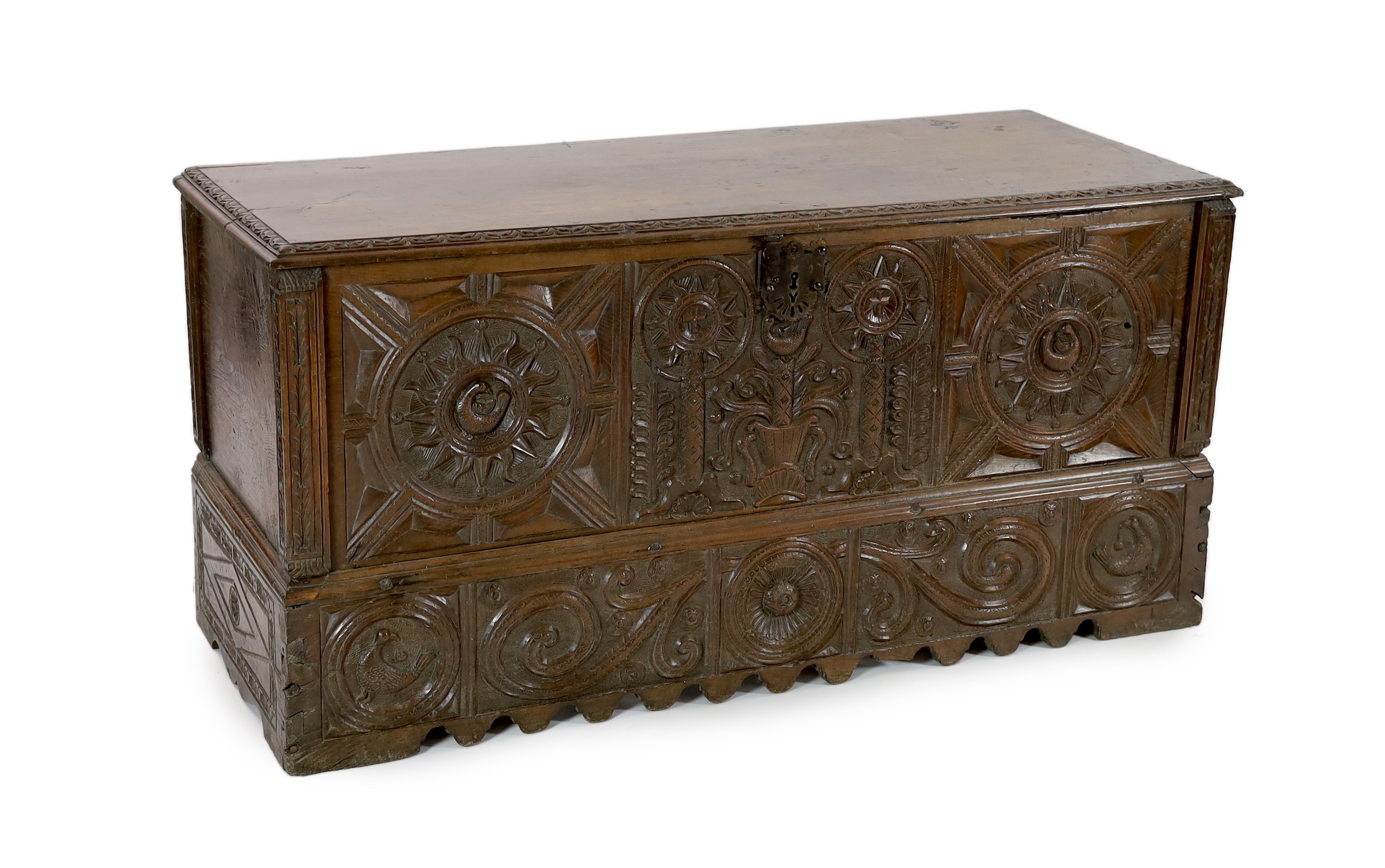 An 18th century Spanish chestnut coffer, carved in relief with a central fountain flanked by