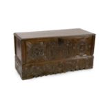 An 18th century Spanish chestnut coffer, carved in relief with a central fountain flanked by