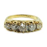 An 18ct gold and graduated five stone diamond set half hoop ring, with carved setting and diamond