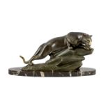 M. Leducq. A patinated spelter model of a panther crouched upon a rock, signed, on oval marble