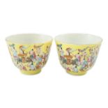 A pair of Chinese yellow ground 'Hundred Boys’ cups, 19th century, each a procession of boys, four