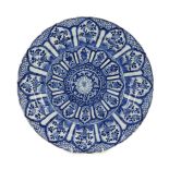 A Chinese blue and white panelled dish, Kangxi period, the centre painted with a lotus flower within