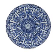 A Chinese blue and white panelled dish, Kangxi period, the centre painted with a lotus flower within