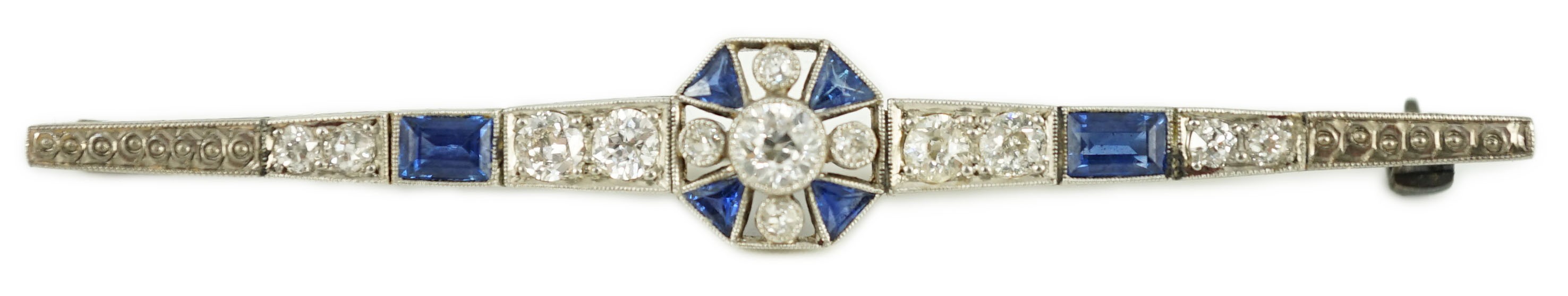 A 1920's/1930's white gold, sapphire and diamond cluster set bar brooch, with central octagonal