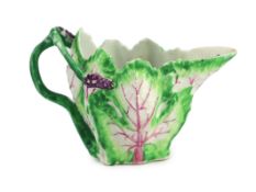 A Longton Hall cream jug, c.1755, modelled in the form of two overlapping vine leaves, the handle