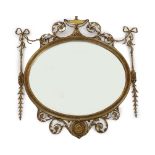 A late Victorian Adam Revival oval wall mirror, with urn, foliate scroll, ribbon and harebell