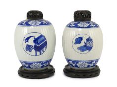 A pair of Chinese blue and white ribbed ovoid jars, Kangxi period, each painted with ‘Antiques’