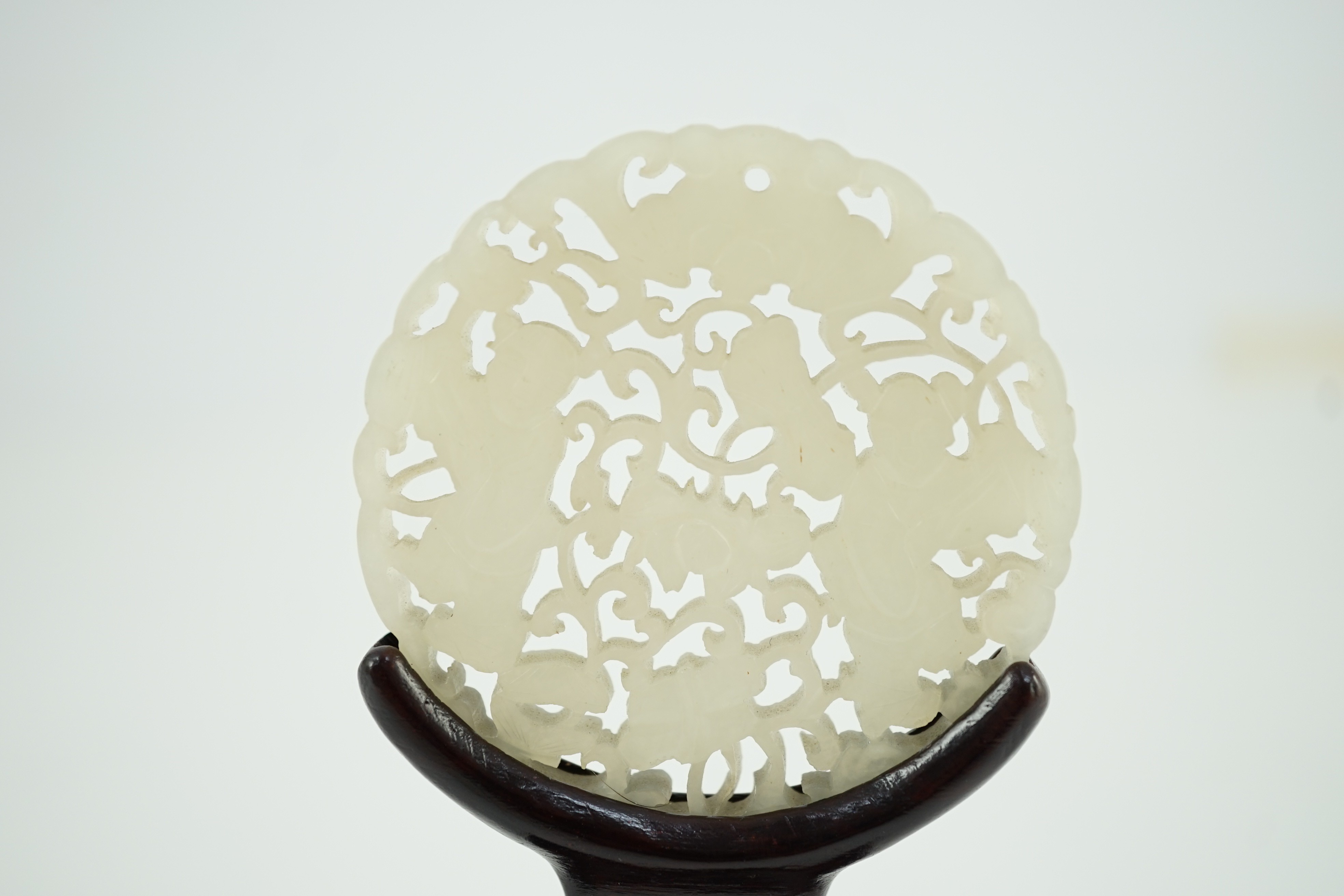 A Chinese white jade ‘Hehe Erxian’ disc, 19th/20th century, carved and pierced with a bat above - Image 4 of 5