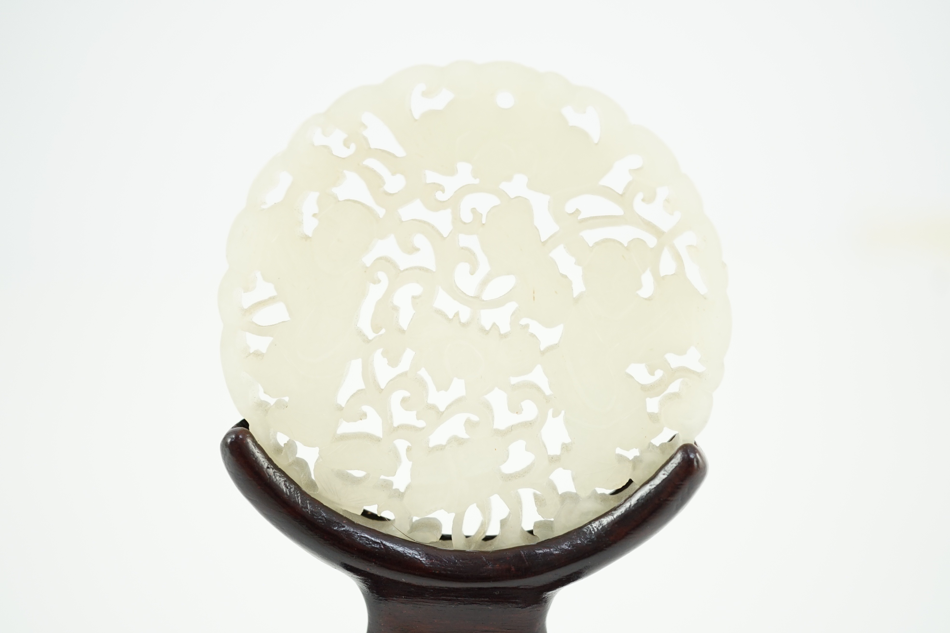 A Chinese white jade ‘Hehe Erxian’ disc, 19th/20th century, carved and pierced with a bat above - Image 2 of 5