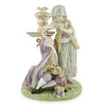 A Meissen porcelain group of a maid and a gallant by a pedestal, 19th century, underglaze blue