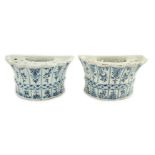 Two similar 18th century Delft blue and white hanging bough pots, of lobed demi-lune shape,