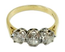 A modern 18ct gold and three stone diamond set ring, the central stone weighing approximately 0.