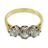 A modern 18ct gold and three stone diamond set ring, the central stone weighing approximately 0.