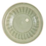A small Chinese Ming Longquan celadon dish, 15th/16th century, the interior with a fluted cavetto,