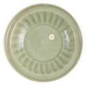 A small Chinese Ming Longquan celadon dish, 15th/16th century, the interior with a fluted cavetto,