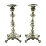 A pair of early 19th century Portuguese silver candlesticks, with engraved decoration, waisted