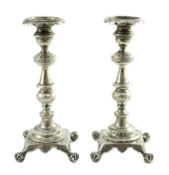 A pair of early 19th century Portuguese silver candlesticks, with engraved decoration, waisted