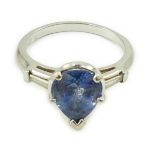 A platinum (10%) and single stone pear cut Ceylon sapphire set ring, with tapered baguette cut