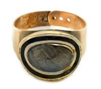 A George III gold and two colour enamel mourning ring, with adjustable 'buckle' shank, with