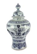 A massive Delft blue and white inverted baluster vase and cover, c.1700, painted with Chinese