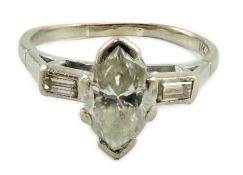 An 18ct white gold and single stone marquise cut diamond set ring, with baguette cut diamond set