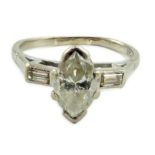 An 18ct white gold and single stone marquise cut diamond set ring, with baguette cut diamond set