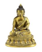 A small Tibetan gilt bronze seated figure of Buddha Shakyamuni, 18th century, on a double lotus