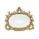 A George III carved giltwood landscape wall mirror, of oval foliate scrolling cartouche shape with