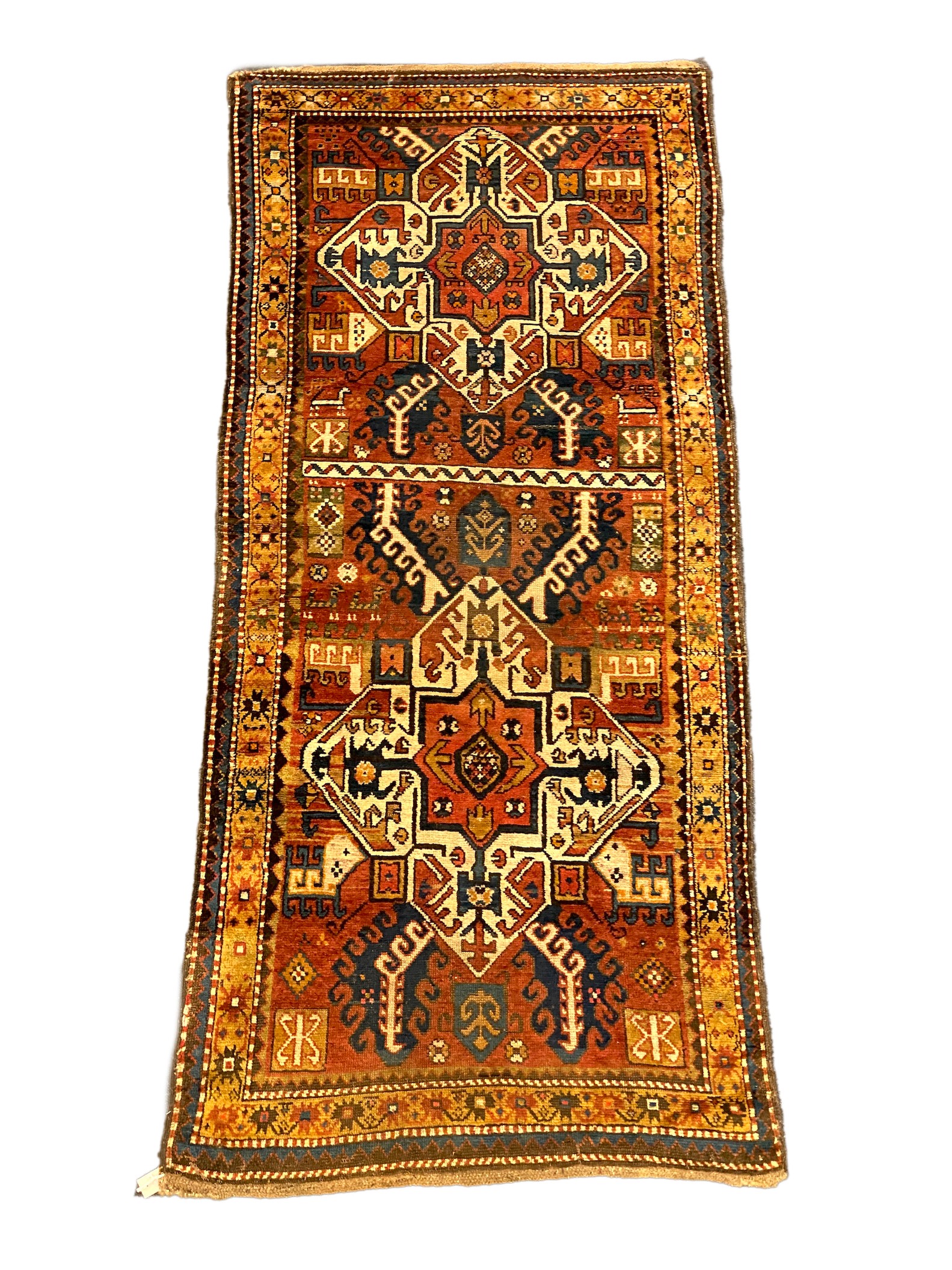 A Kazak red ground rug, with central medallions and geometric motifs, multi-bordered, 240 x