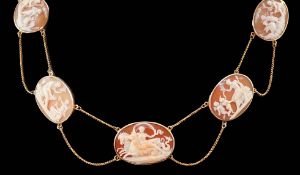 A late Victorian gold and graduated oval cameo shell necklace, with twin strand fine chain links and
