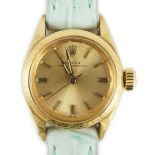 A lady's 18ct gold Rolex Oyster Perpetual wrist watch, on associated leather strap, with baton